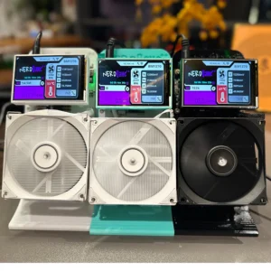 Three NeroJane BM1370 screen firmware upgrade setups, each displaying performance metrics. White and black cooling fans sit below the screens, showing voltage, amperage, temperature, and hashing speed data.